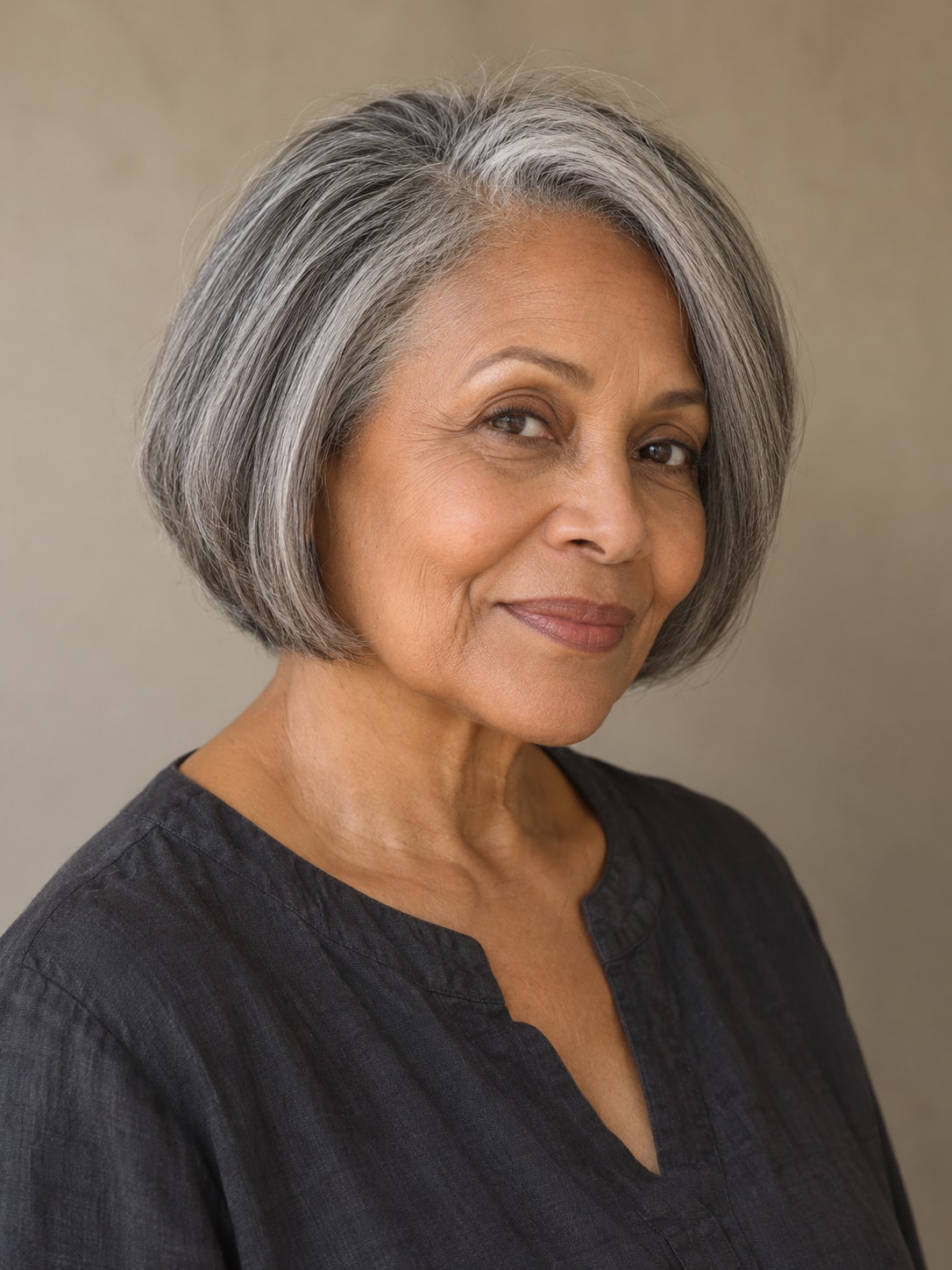 Older woman with a rounded salt-and-pepper bob, a subtle side part and no bangs